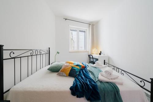 a bedroom with a bed with towels on it at Kalès home in Otranto in Otranto