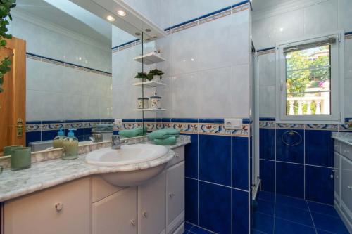 a bathroom with a sink and a glass shower at Villa Encantada in Arona