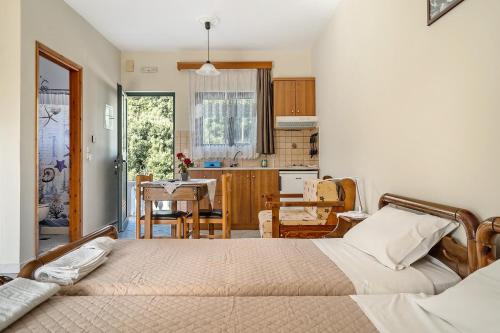 a bedroom with a bed and a dining room at Daratos studio 2 in Kefallonia
