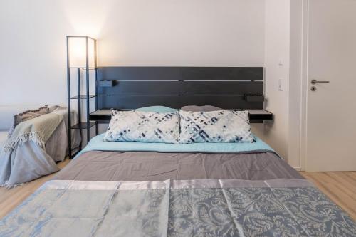 a bedroom with a large bed with a black headboard at Ferienwohnung Im Haidelmoos in Konstanz