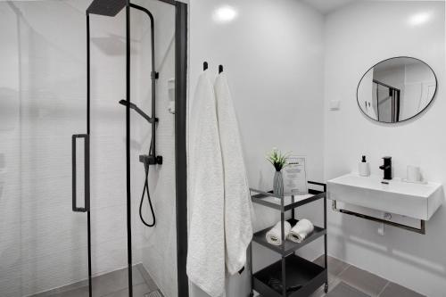 a bathroom with a shower and a sink at Babosas Charm in Funchal
