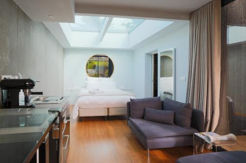 a living room with a couch and a bed at Ecolodge à 300m de la plage in Pléneuf-Val-André