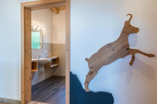 a bathroom with a piece of wood on the wall at Apt Gamsstube in Maranza