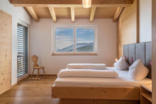 two beds in a room with a window at Apt Gamsstube in Maranza