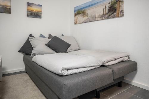 a bed with two pillows on top of it at Ferienwohnung Heide 2 in Walsrode