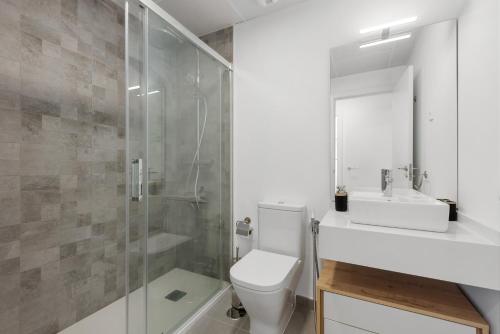 a bathroom with a shower and a toilet and a sink at Adhara 053 in Torre del Mar