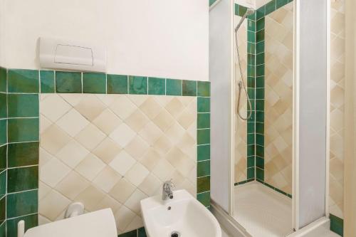 a bathroom with a sink and a toilet and a shower at Residence Orizzonti app n 3 in Golfo Aranci