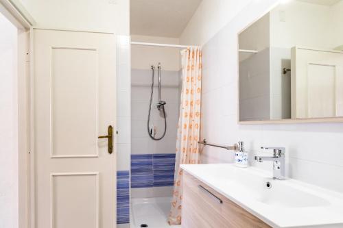 a bathroom with a sink and a shower at Sea Shell Isola Rossa in Isola Rossa