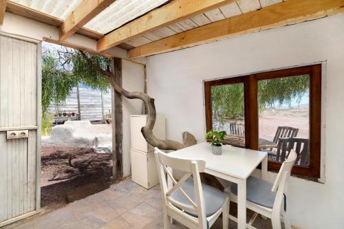 a dining room with a white table and chairs at Aloe Art in Teguise