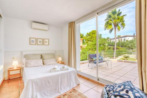 a bedroom with a bed and a large window at Casa Suca in Santa Ponsa