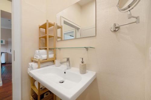 a bathroom with a white sink and a mirror at Alte Stadtvilla am Weinberg 1 in Traben-Trarbach