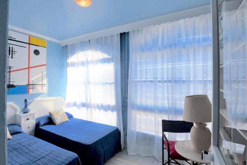 a bedroom with two beds and a window at La huerta de Bonela in Casarabonela