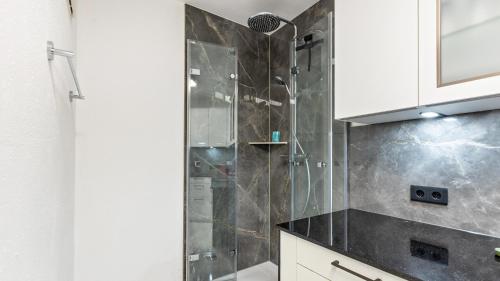 a shower with a glass door in a bathroom at Fewo-Gottmadingen in Gottmadingen