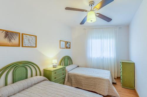 a bedroom with two beds and a ceiling fan at A222 El Recreo in Torrox