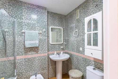 a bathroom with a sink and a shower and a toilet at A222 El Recreo in Torrox