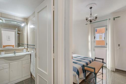 a bathroom with a bed and a sink and a mirror at Casa Goro in Tazacorte