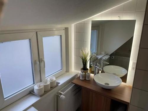 a bathroom with a sink and a mirror at room4rent in Lingen