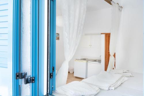 a room with a bed and a window at Beachfront Lampis Dolphin 3 in Skala