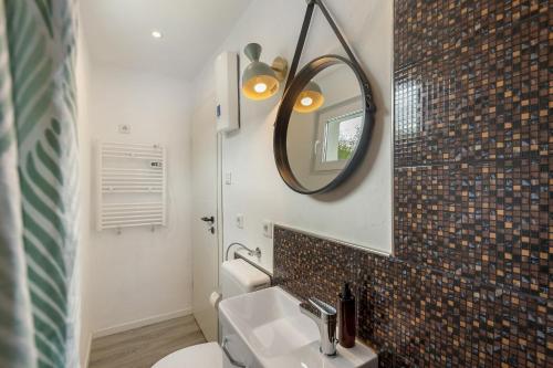 a bathroom with a sink and a mirror at Casa Verde Sauerland in Lennestadt