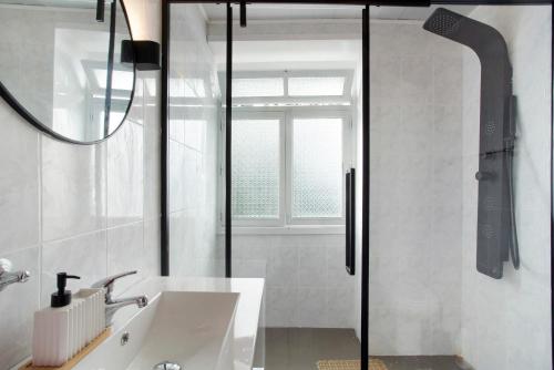 a bathroom with a sink and a shower at Carros De Cesto Do Monte in Funchal
