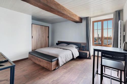 a bedroom with a bed and a large window at Chambres d'hôtes Le Plessis in Frossay