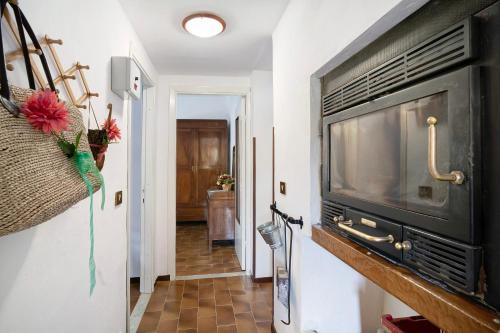 a hallway with a flat screen tv on a wall at Câ de Bacî in Vessalico