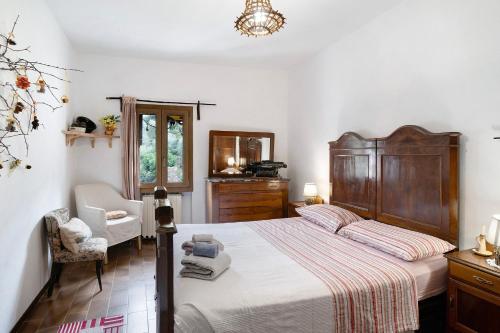 a bedroom with a large bed and a chair at Câ de Bacî in Vessalico
