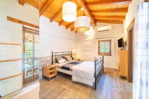 a bedroom with a bed and a tv in a room at Mini Country House in Sidari