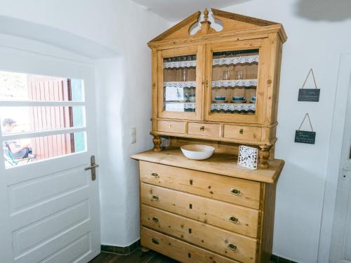 a wooden cabinet with a bowl on top of a dresser at Connyhaus St Oswald ob Eibiswald in Sankt Oswald ob Eibiswald