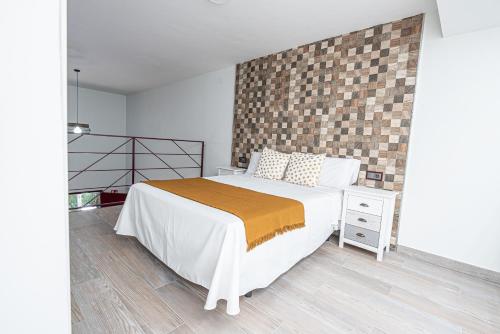a bedroom with a bed and a brick wall at Ocean Suites A5 in Isla Cristina