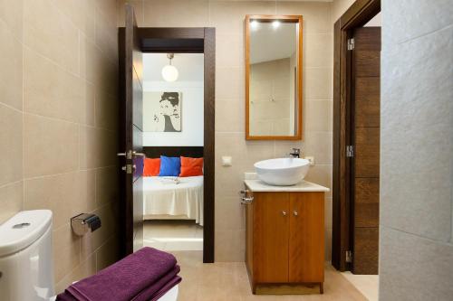 a bathroom with a sink and a mirror at Las Perseidas in Costa Teguise