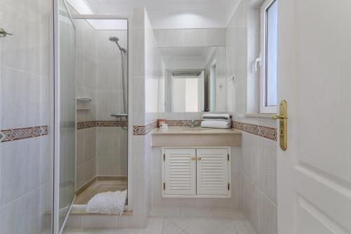 a bathroom with a shower and a sink at Villa Karon in Almancil