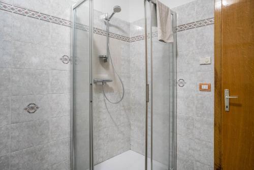 a shower with a glass door in a bathroom at Lases Piano Terra in Albiano
