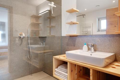 a bathroom with a sink and a shower at Ferienhaus Tholer Hof in San Genesio Atesino