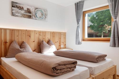 two beds in a room with a window at Ferienhaus Tholer Hof in San Genesio Atesino