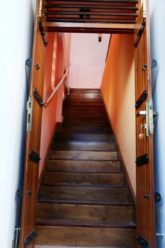 a staircase leading up to a room with orange walls at The Cool Nest Yala Hotel in Tissamaharama