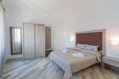 a bedroom with a bed and a mirror at Appartamento Castula in Dorgali