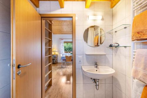 a bathroom with a sink and a mirror at Ferienhaus Katrin in Bad Urach