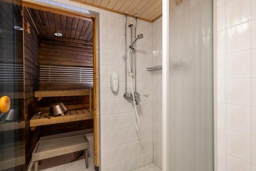 a bathroom with a shower and a sink at Santa's Hotel Tunturi in Saariselka