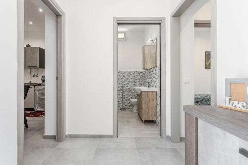 a hallway with a bathroom with a toilet and a sink at Villa Mare Blu in Palermo