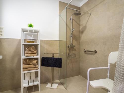 a bathroom with a shower and a towel rack at 'Mi Esperanza' in Almuñécar