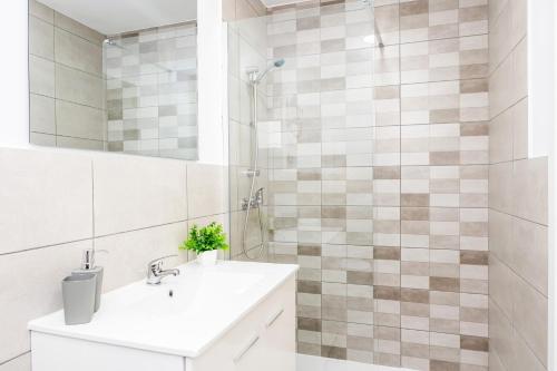 a white bathroom with a sink and a shower at Gran Sol Family 6 in Felanitx
