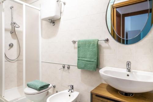 a bathroom with a sink and a toilet and a mirror at Belvedere in Scarlino