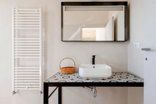 a bathroom with a sink and a mirror at Casale 50 Elegante Villa a Otranto in Otranto