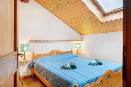 a bedroom with a bed with two pairs of shoes on it at Casa Serena in Cavalese