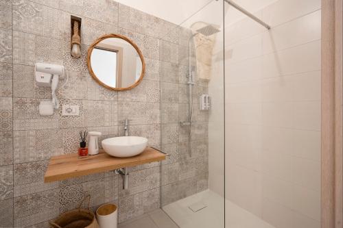 a bathroom with a sink and a shower at Dimora Giulia in Castellana Grotte