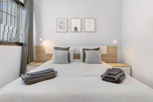 a bedroom with a white bed with two towels on it at Bungalow Seaview in San Bartolomé