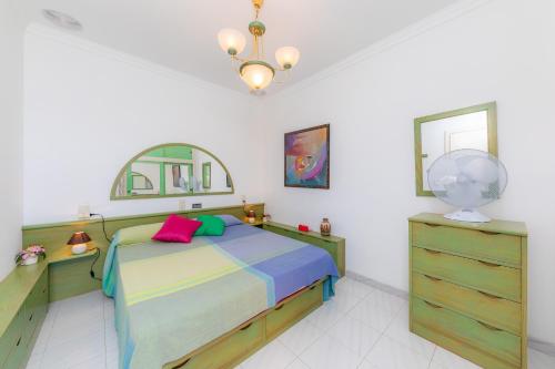 a bedroom with a bed and a mirror and a dresser at Ca Na Xisca in Sa Coma