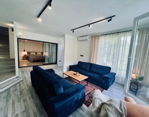 a living room with blue couches and a table at Apartment Anur in Bihać