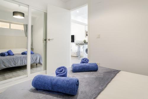 a bedroom with two blue pillows on the floor at Boliche in Benimagrell